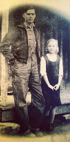 Charlie Johns, 22 and his wife Eunice, 9, outside a cabin home in rural Tennessee in 1937.
