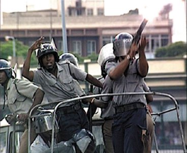 Black riot police in Zimbabwe from the film Zimbabwe Countdown (2003) by the disillusioned white liberal Michael Raeburn