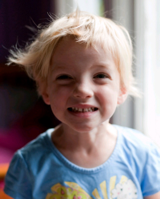 A little girl’s artificial smile, suggested as a defence mechanism